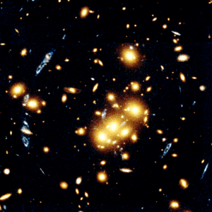 Background galaxy (blue) being gravitationally lensed by dark matter in foreground cluster CL 0024+1654 (yellow)<br>(Hubble Space Telescope image)
