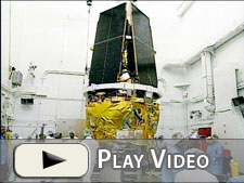 Pre-launch spacecraft preparations in a clean room at Vandenberg AFB, CA