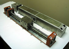 A Mass Trim Mechanism (MTM), consisting of a moveable weight, mounted on a long screw shaft that is turned by a motor.